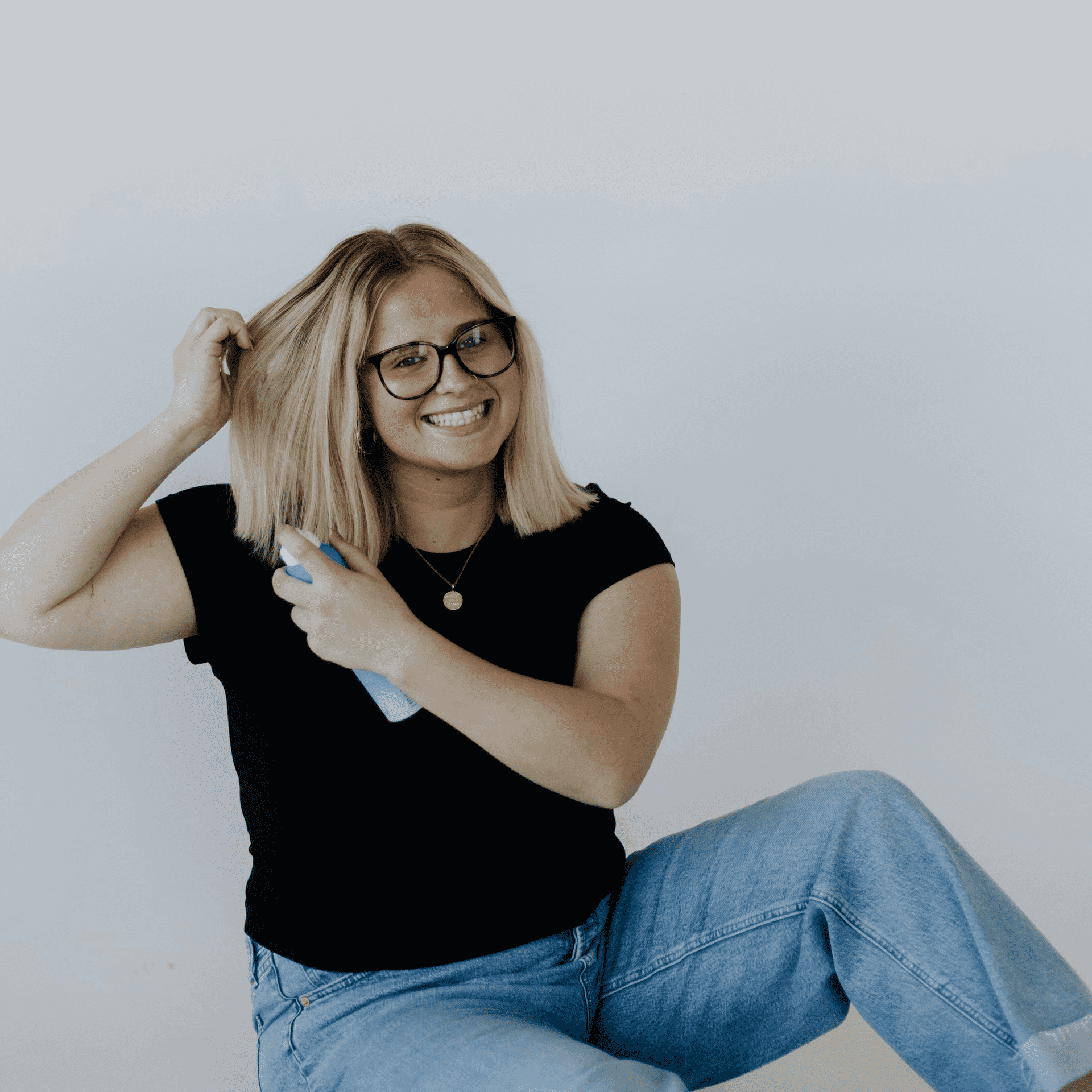 Portrait of Kadee, a professional stylist at Hairitage, showcasing their expertise and style.